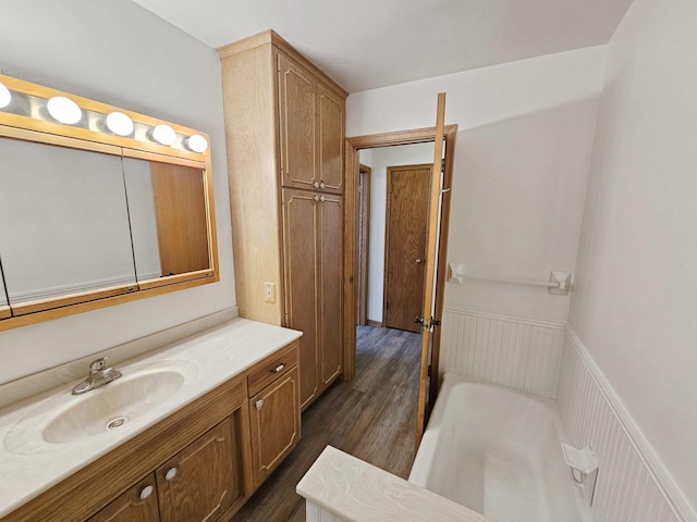 bathroom with vanity, a bathtub, and wood-type flooring