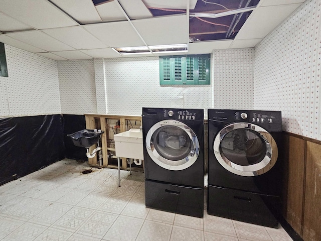 washroom with independent washer and dryer and sink