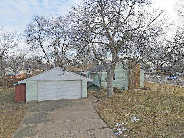 view of front of home with a garage and an outdoor structure