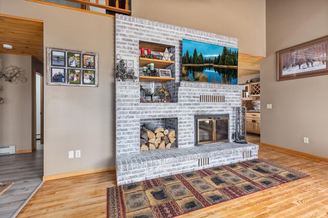 1378 Larrup Trl SW, Pine River, MN 56474 - living area with wood finished floors, a fireplace, baseboards, and a baseboard heating unit
