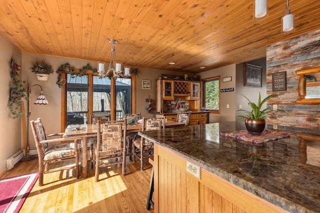 1378 Larrup Trl SW, Pine River, MN 56474 - dining area featuring a chandelier, light wood finished floors, a baseboard heating unit, and wood ceiling