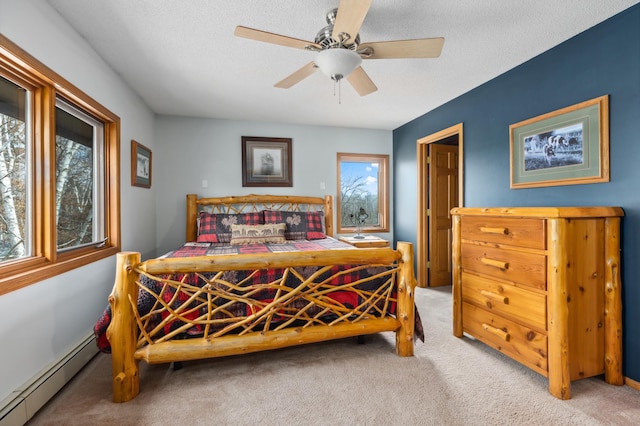 1378 Larrup Trl SW, Pine River, MN 56474 - bedroom with a baseboard radiator, multiple windows, carpet floors, ceiling fan, and a textured ceiling