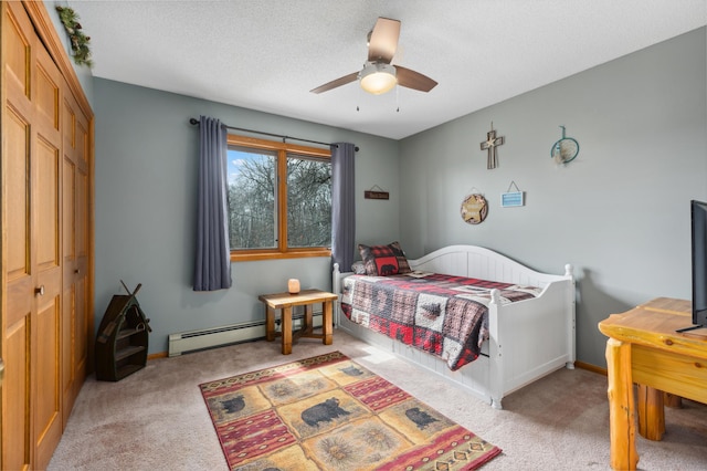 1378 Larrup Trl SW, Pine River, MN 56474 - carpeted bedroom with baseboard heating, a closet, a ceiling fan, baseboards, and a textured ceiling
