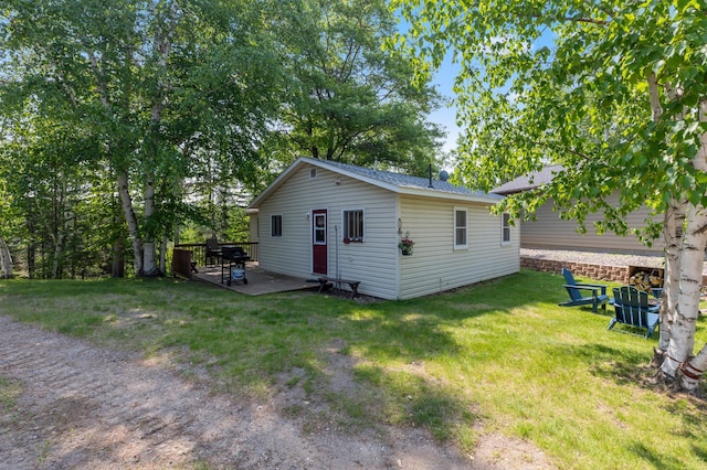 1378 Larrup Trl SW, Pine River, MN 56474 - rear view of property with a wooden deck, a lawn, and an outbuilding