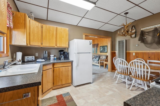 1378 Larrup Trl SW, Pine River, MN 56474 - kitchen featuring freestanding refrigerator, a drop ceiling, a sink, dark countertops, and wainscoting