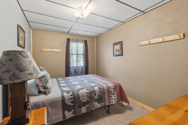 1378 Larrup Trl SW, Pine River, MN 56474 - carpeted bedroom with a textured wall, a drop ceiling, and baseboards