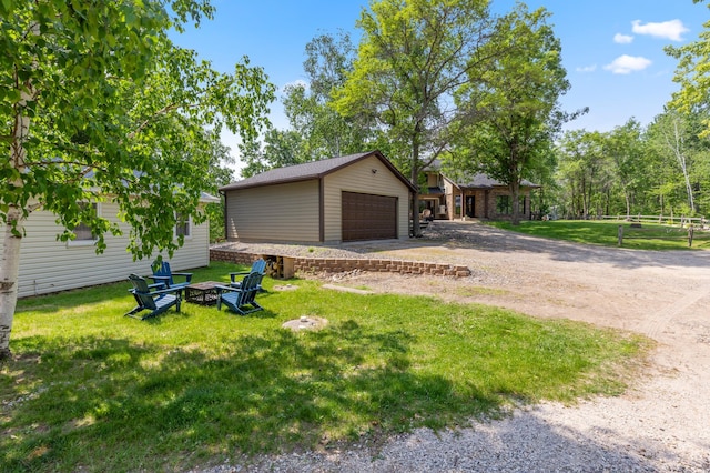 1378 Larrup Trl SW, Pine River, MN 56474 - view of front of house with an outbuilding, a garage, a front lawn, and a fire pit