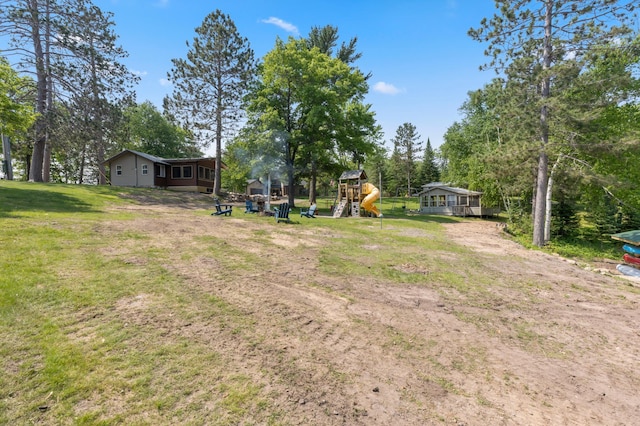 1378 Larrup Trl SW, Pine River, MN 56474 - view of green lawn featuring a playground and view of scattered trees