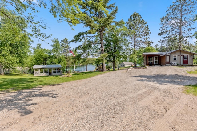 1378 Larrup Trl SW, Pine River, MN 56474 - view of front of home featuring dirt driveway, a front lawn, a water view, and view of wooded area