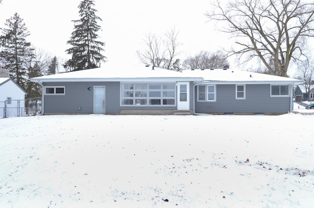 view of snow covered rear of property