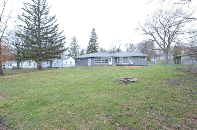 view of yard featuring a fire pit and a fenced backyard