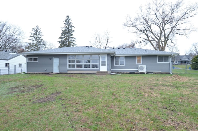back of property with a yard and fence