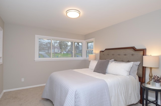 carpeted bedroom with baseboards