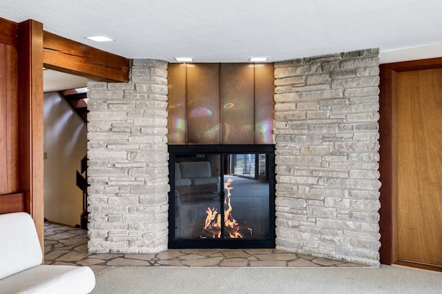 details with carpet floors and a lit fireplace