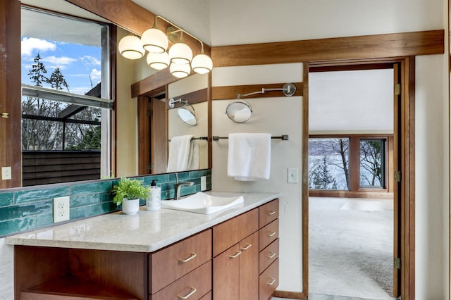 bathroom featuring plenty of natural light, backsplash, and vanity