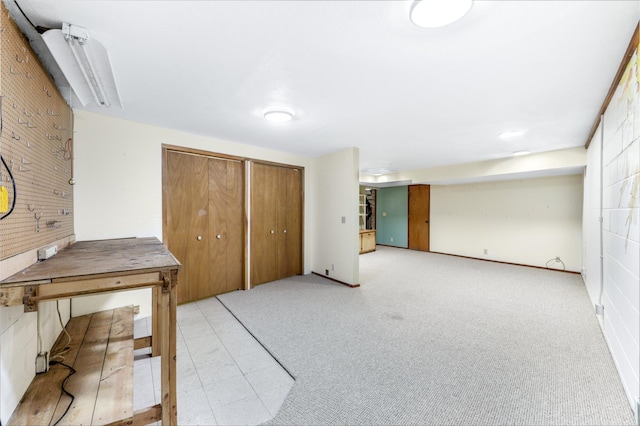 interior space with light carpet and a closet