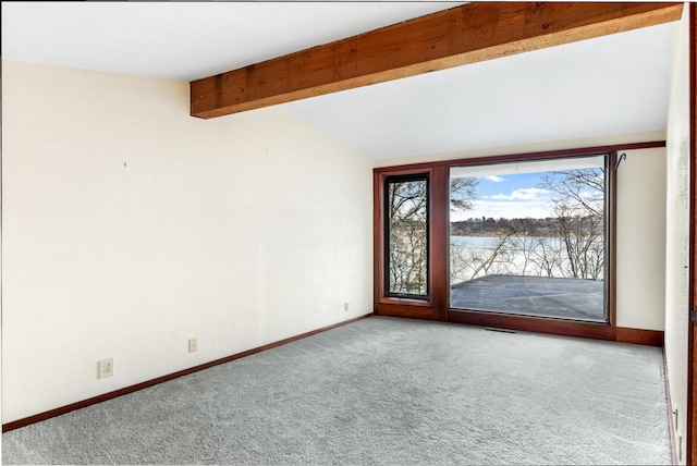 empty room with carpet floors, vaulted ceiling with beams, and baseboards