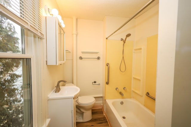 full bathroom featuring vanity, wood-type flooring,  shower combination, and toilet