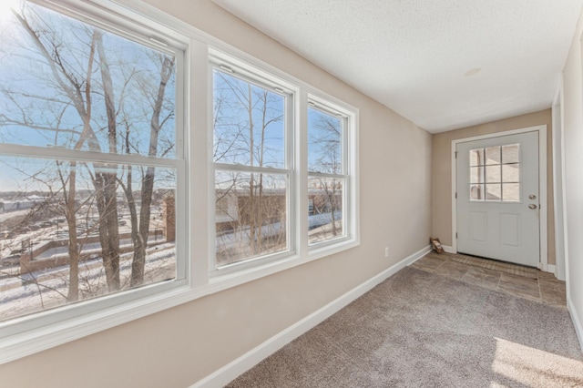 interior space featuring carpet floors and a textured ceiling