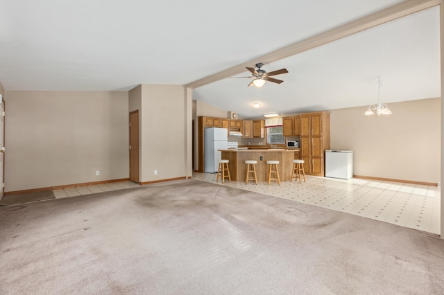 unfurnished living room with lofted ceiling with beams, ceiling fan with notable chandelier, and light carpet