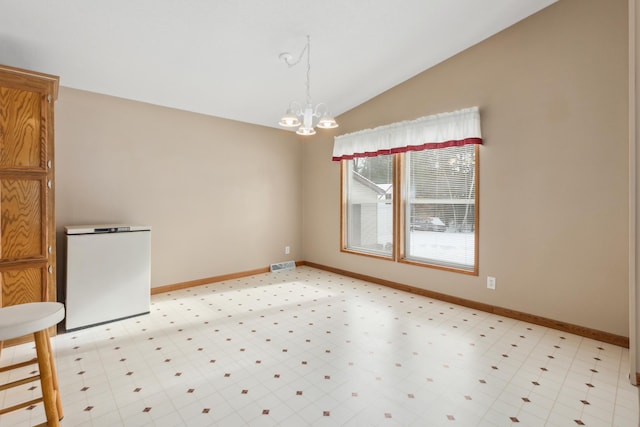 unfurnished dining area with a chandelier and vaulted ceiling