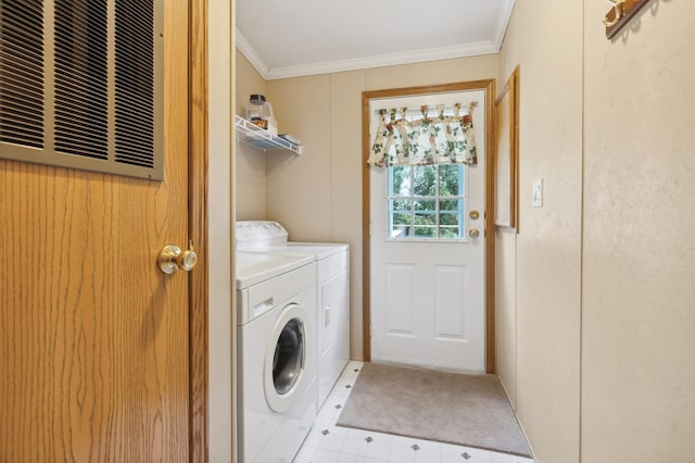 clothes washing area with crown molding and washing machine and clothes dryer