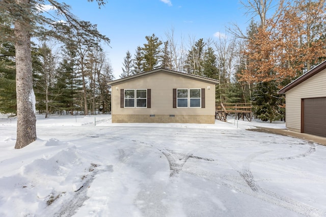 view of snow covered exterior featuring a garage