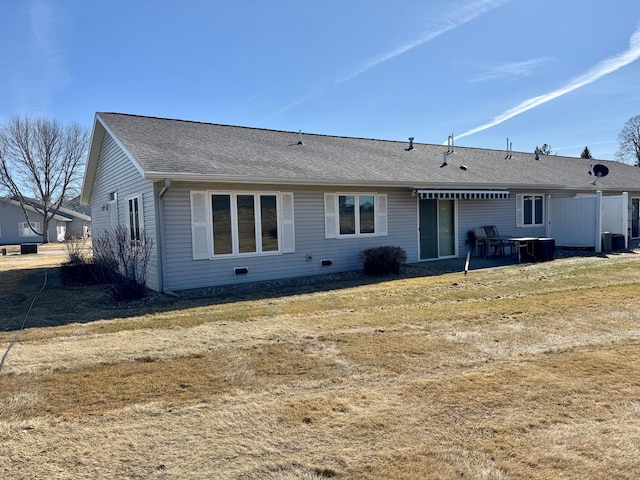 back of property featuring a patio area and roof with shingles