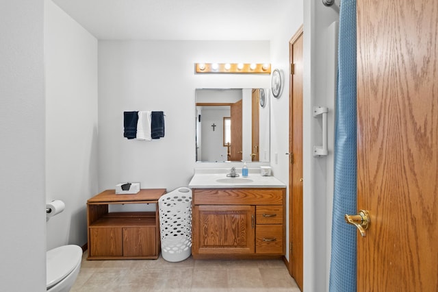 bathroom featuring vanity, toilet, and tile patterned flooring