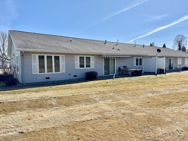 rear view of property featuring a patio and roof with shingles