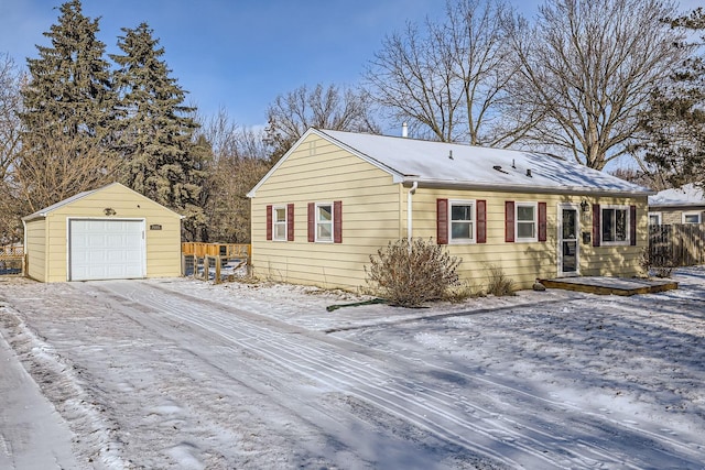 view of front of home with a garage and an outbuilding