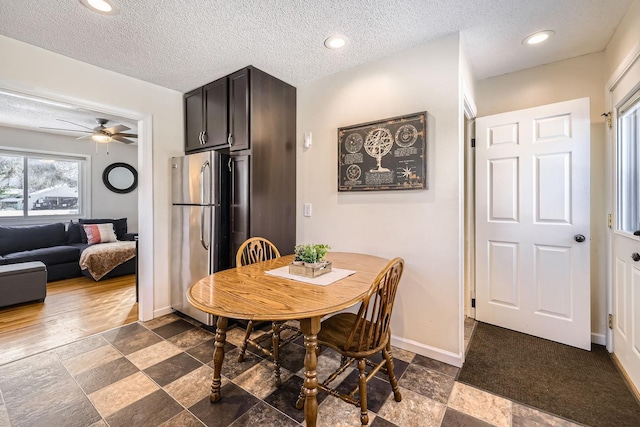 dining room with ceiling fan and a textured ceiling