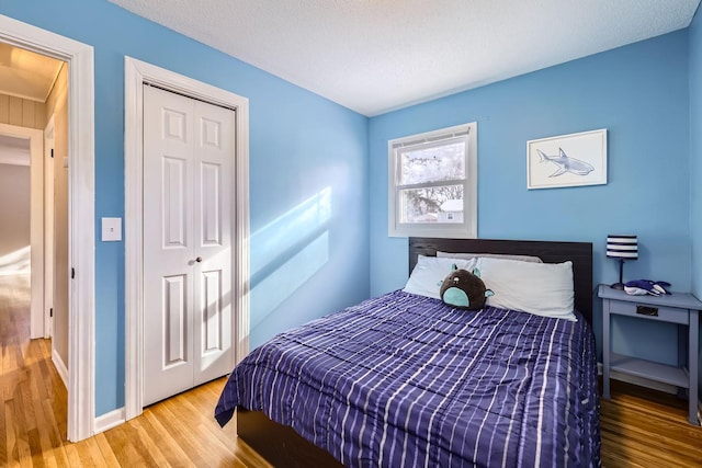 bedroom with hardwood / wood-style floors and a closet