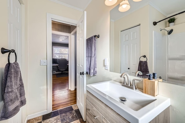 bathroom featuring vanity, a shower, and ornamental molding