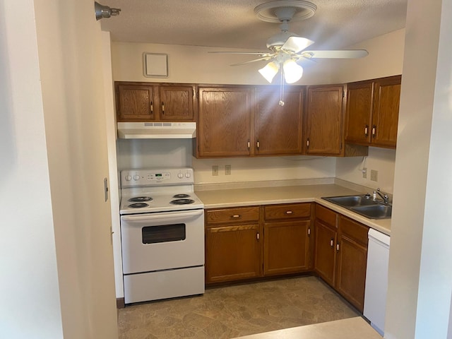 kitchen featuring ceiling fan, white appliances, sink, and a textured ceiling