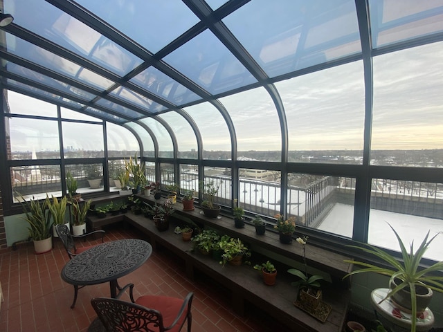 sunroom with a water view and plenty of natural light