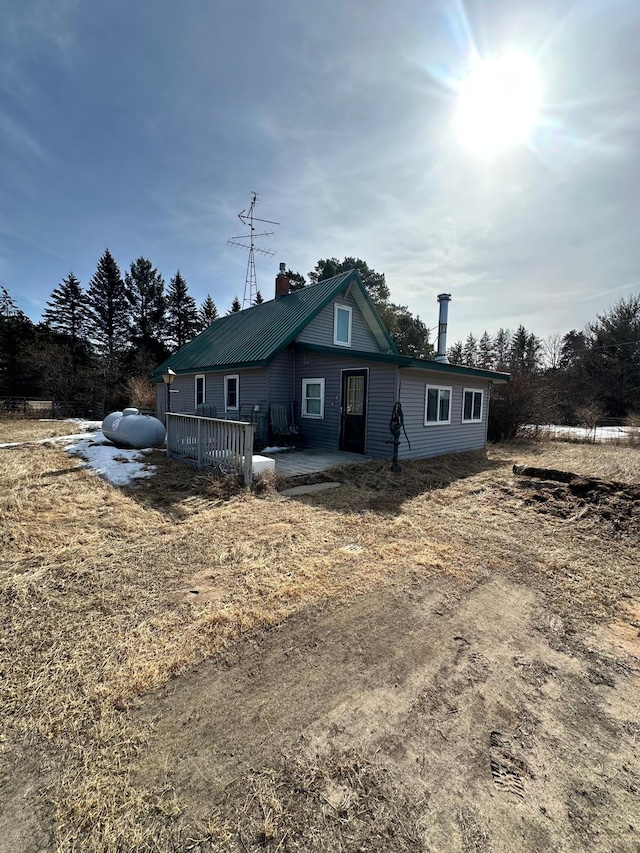 view of front of home with a patio area and a chimney