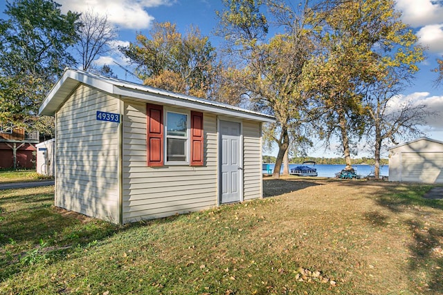 view of outbuilding with a water view and an outdoor structure