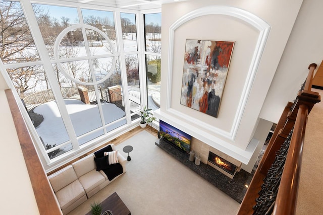 carpeted living room with a tile fireplace and a healthy amount of sunlight