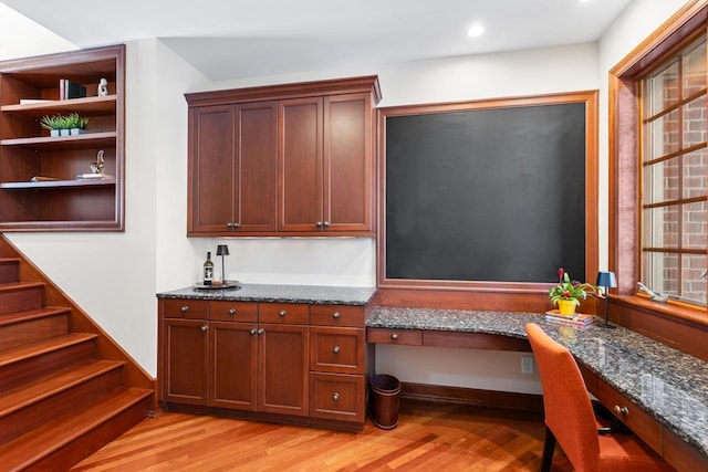 interior space with plenty of natural light, built in desk, light wood-type flooring, and recessed lighting