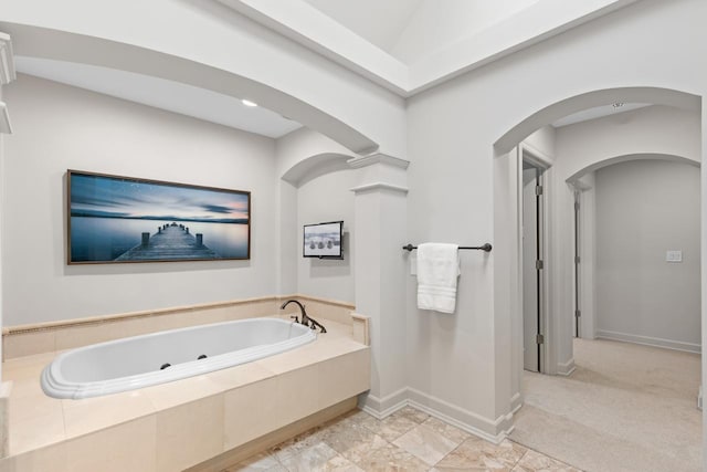 full bath featuring a tub with jets and baseboards