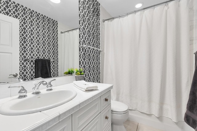 bathroom featuring tile patterned flooring, vanity, and toilet