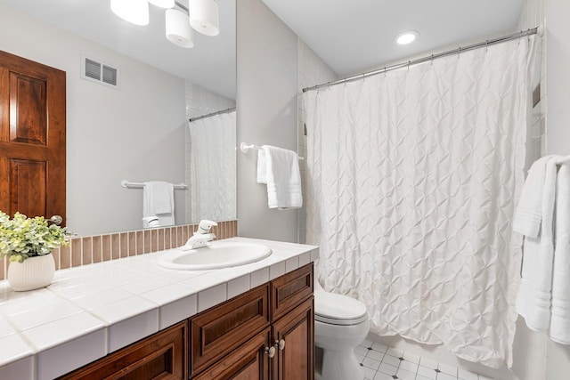 full bathroom with toilet, visible vents, and vanity