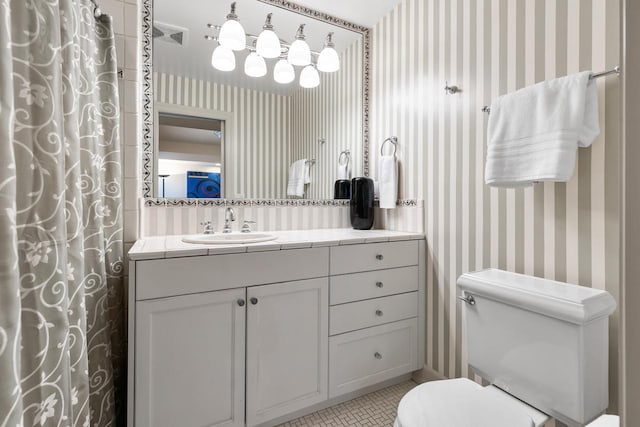 full bathroom with curtained shower, wallpapered walls, toilet, vanity, and tile patterned floors