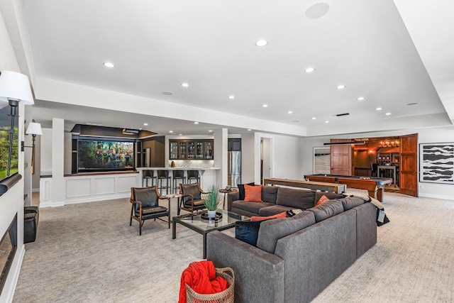 living room with a bar, recessed lighting, billiards, and light colored carpet