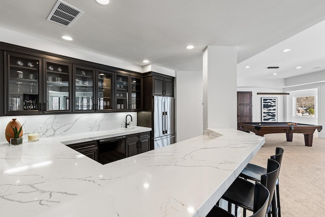 bar with high quality fridge, light colored carpet, a sink, visible vents, and dishwasher