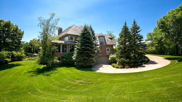 exterior space featuring a chimney and a front lawn