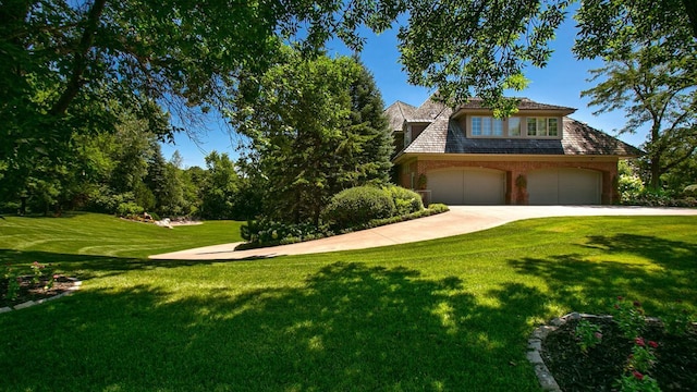 view of front of home with a garage, concrete driveway, and a front lawn