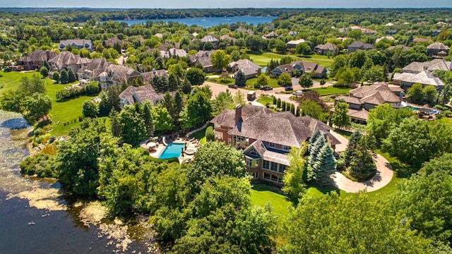 drone / aerial view with a water view and a residential view