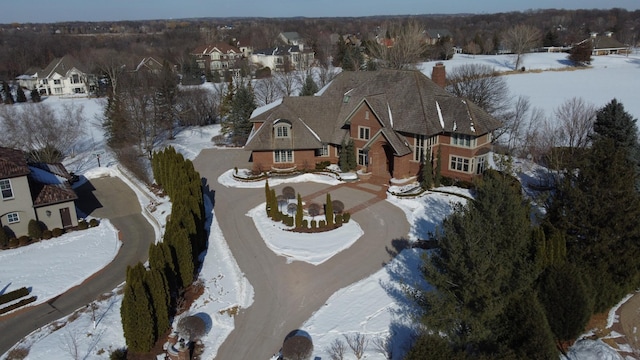 snowy aerial view with a residential view